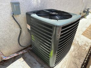 A newly installed outdoor AC condenser unit next to a residential building by Honest AC Experts in Las Vegas, NV