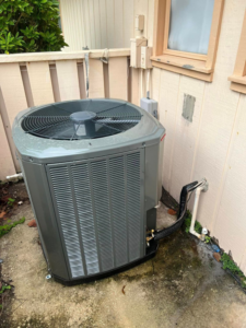 A new outdoor AC condenser unit installed next to a building by AC All Stars AC contractor in Fort Lauderdale, FL.