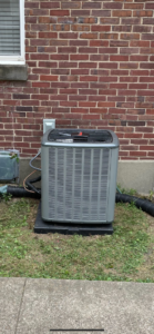A newly installed outdoor AC condenser unit by Legacy Heating & Air Conditioning LLC in Louisville, KY