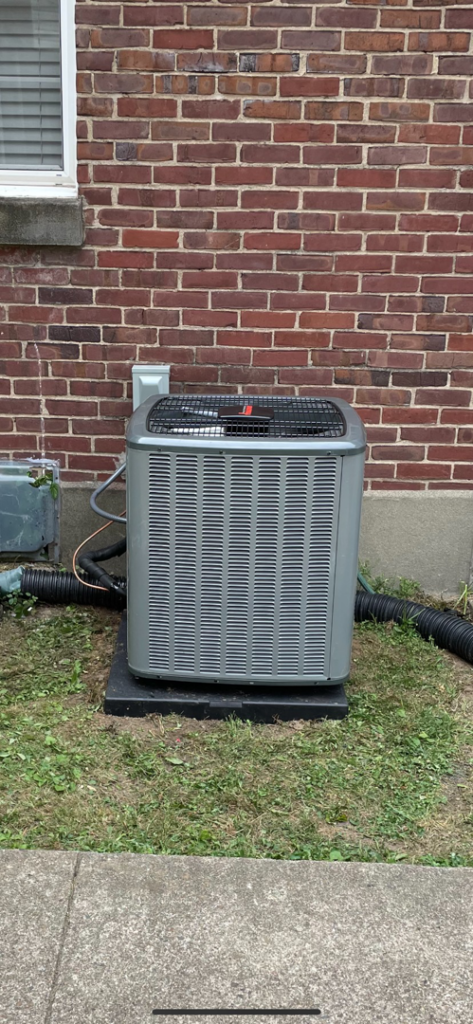 A newly installed outdoor AC condenser unit by Legacy Heating & Air Conditioning LLC in Louisville, KY