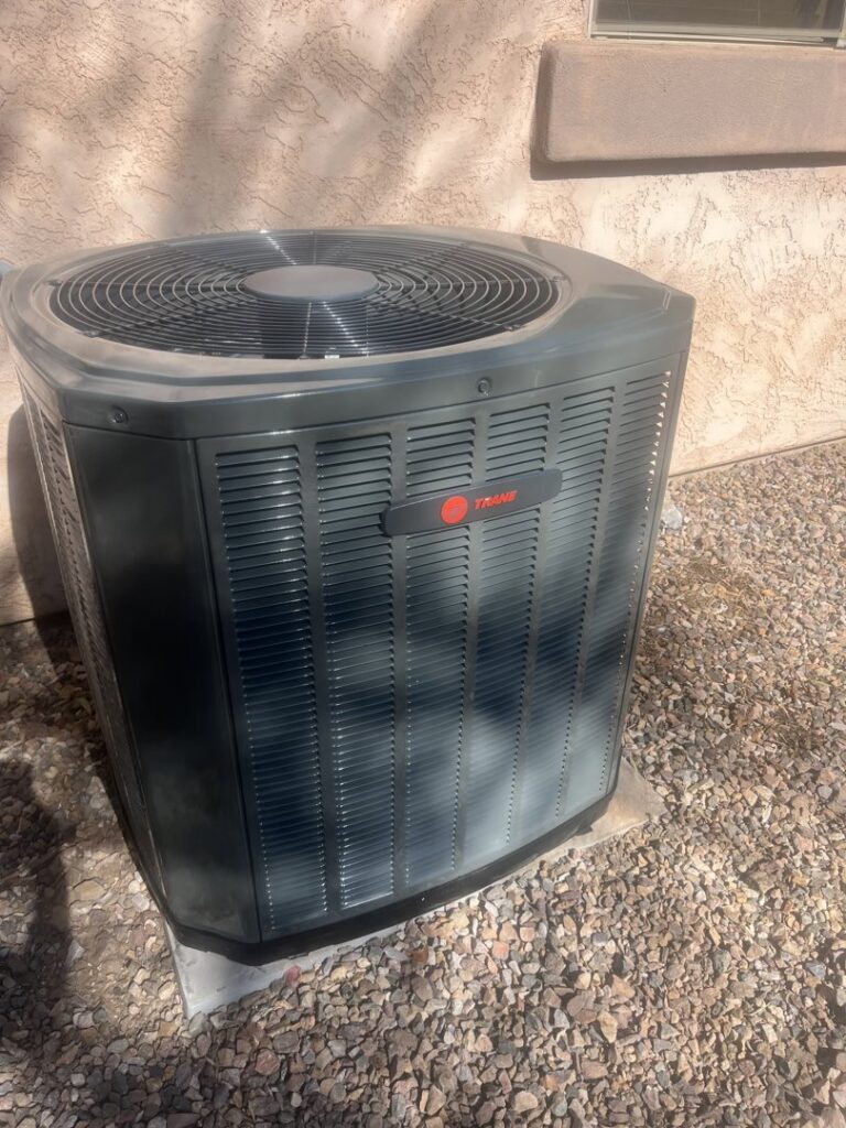 A new outdoor AC condenser unit installed at a residential property by Ash Cooling & Heating in Mesa, AZ.