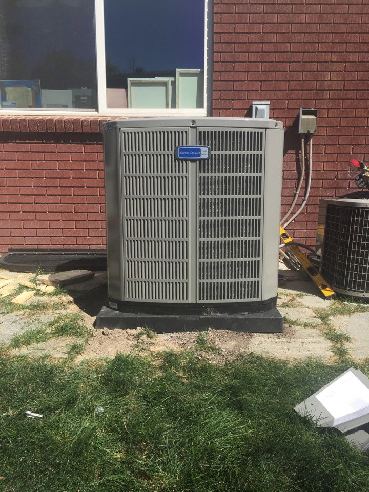 A newly installed outdoor air conditioning unit next to a brick wall by Any Climate Mechanical HVAC in Sandy, UT.