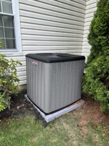 A newly installed outdoor air conditioning unit next to a residential home by Falso Service Experts in East Syracuse, NY.