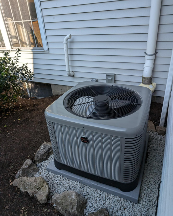 A newly installed Rheem outdoor air conditioning unit by Frank N Frank Mechanical Contractors in Rochester, NY.