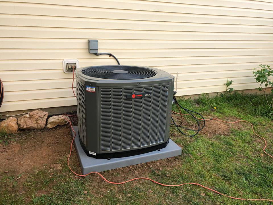A newly installed outdoor AC unit next to a house by Fred's Heating And Cooling in Charlotte, NC