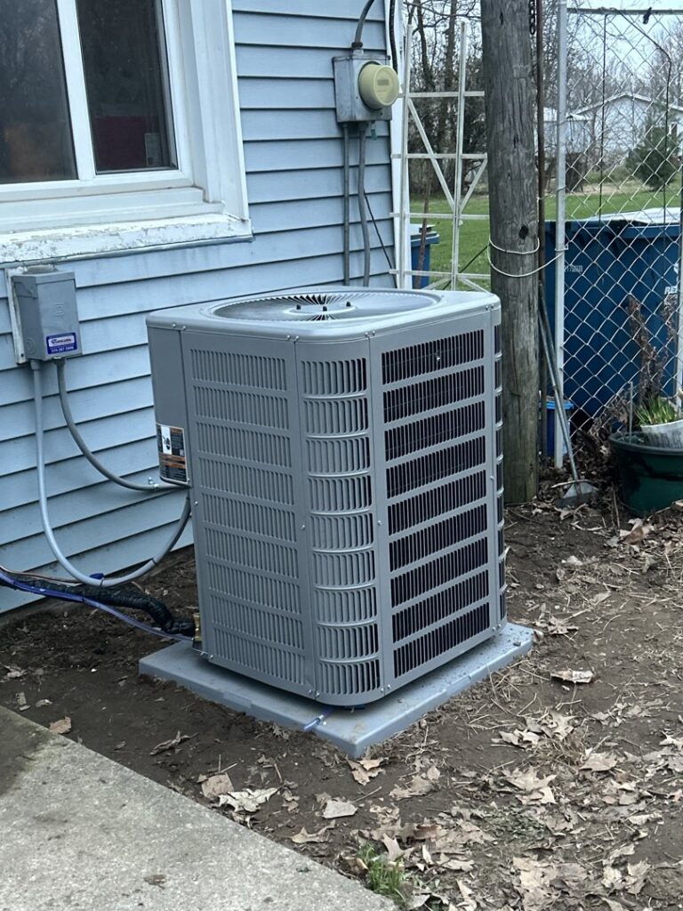 A newly installed outdoor air conditioning unit next to a residential home by Great Lakes Heating & Air Conditioning in Wickliffe, OH.