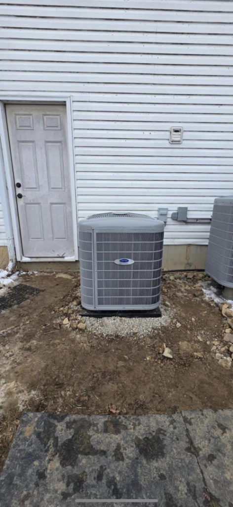A newly installed outdoor AC unit next to a white siding house by Pike Mechanical in Vevay, IN.