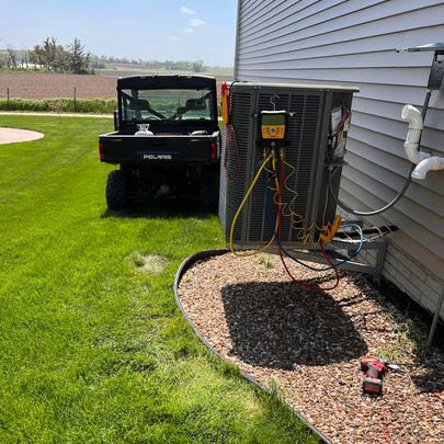 A newly installed outdoor air conditioning unit next to a home, completed by TruLine HVAC in Cedar Rapids, IA.