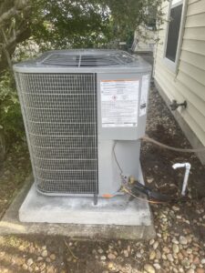 A newly installed outdoor air conditioning unit next to a residential home by Whitleys Heating and Air in Jacksonville, FL.