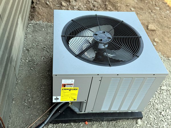 A new outdoor air conditioning unit with an EnergyGuide label installed by QC Mechanical, Inc. in Lockport, NY.