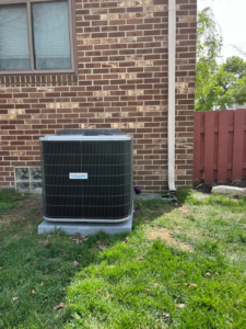 A newly installed outdoor air conditioner unit on a concrete pad by Motown Mechanical Heating And Cooling in Westland, MI.