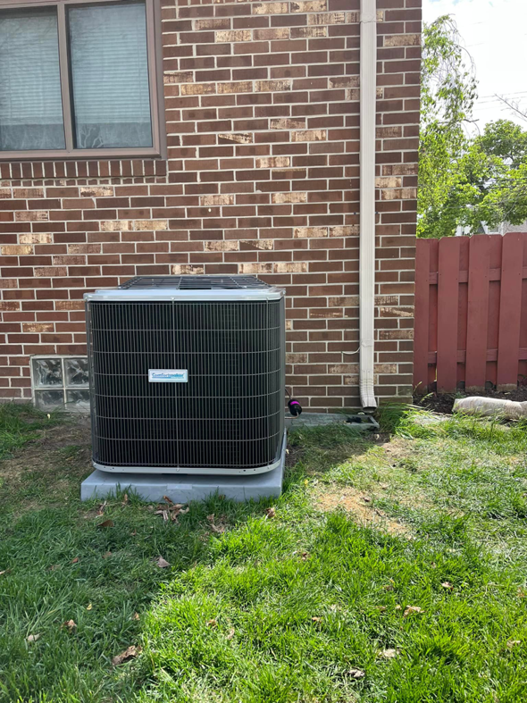 A newly installed outdoor air conditioner unit on a concrete pad by Motown Mechanical Heating And Cooling in Westland, MI.