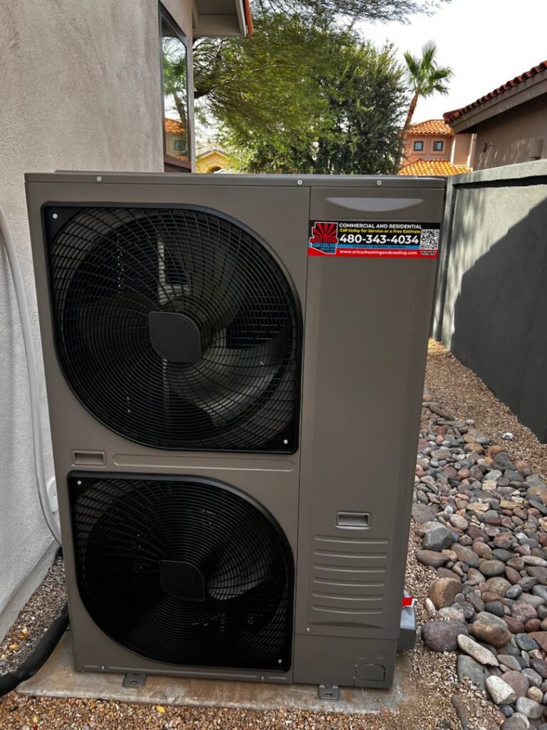 A newly installed outdoor heat pump unit by Arizaz Heating & Cooling next to a residential property in Chandler, AZ.