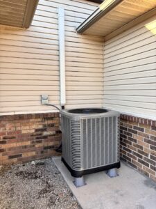 New outdoor HVAC condenser unit installed next to a residential home by ACE Heating & Cooling, Inc. in Jonesboro, AR