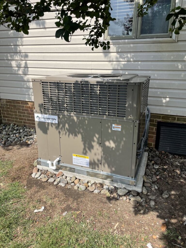 A new outdoor HVAC condenser unit installed next to a residential building by Coastal Breeze Heating-Cooling-Plumbing in Hampton, VA.
