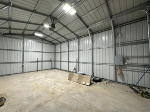 New overhead lighting and electrical panel installed in a metal building by Current Solutions Electric in Boca Raton, FL