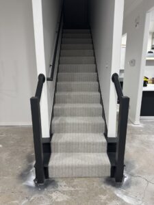 A staircase with new light grey patterned carpet installed by Carpet Depot Okc in Oklahoma City, OK.