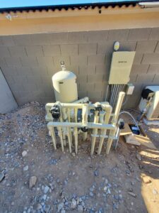 New pool equipment, including a large filter and complex plumbing, installed by EZ POOL Solutions in Tucson, AZ