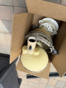 New or replacement pool equipment parts in a cardboard box, ready for installation by Big Foot Pool Care in Buckeye, AZ