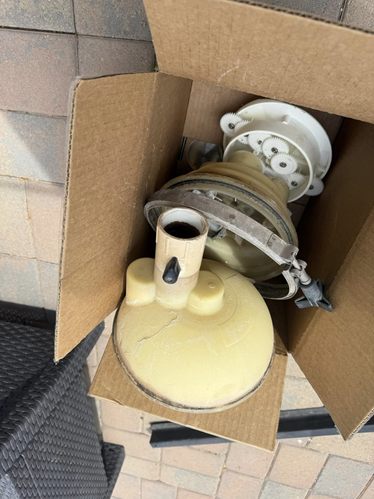New or replacement pool equipment parts in a cardboard box, ready for installation by Big Foot Pool Care in Buckeye, AZ