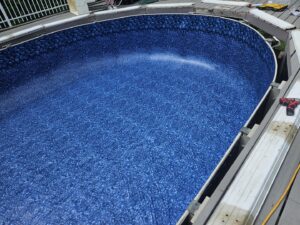 A newly installed pool liner being filled with water in a different pool, showcasing expert liner installation by Westside Pools in Owensboro, KY.
