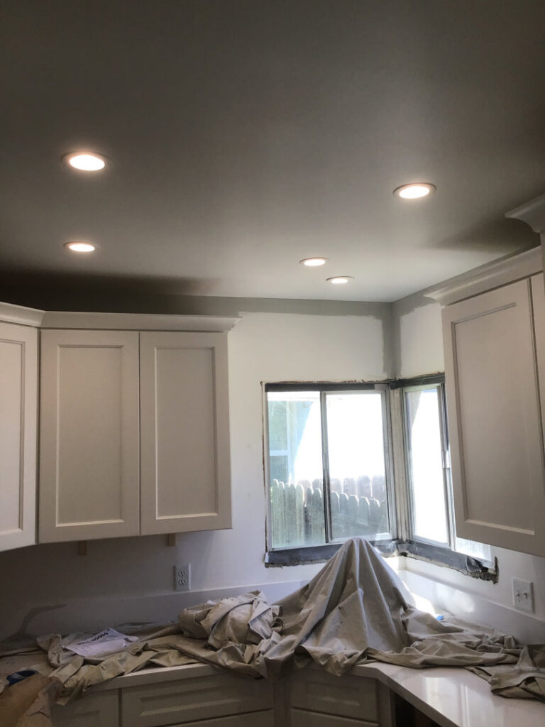 A modern kitchen featuring newly installed recessed lighting in the ceiling, completed by AAA Electrical Services in Sacramento, CA.