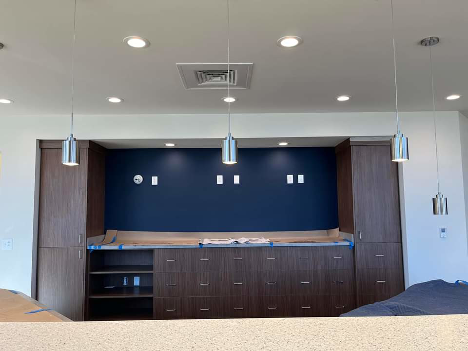 Newly installed recessed and pendant lighting in a modern room, completed by ELEC LLC in Winston-Salem, NC.