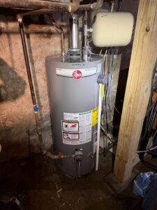 A new Rheem water heater installed in a basement by Dynamic Comfort Solutions, providing reliable service in York, PA.