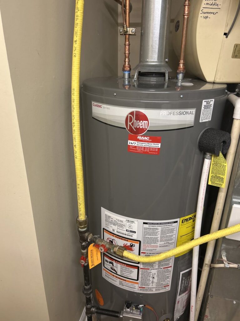 A newly installed Rheem water heater with Isaac Heating & Air Conditioning service sticker in Rochester, NY.