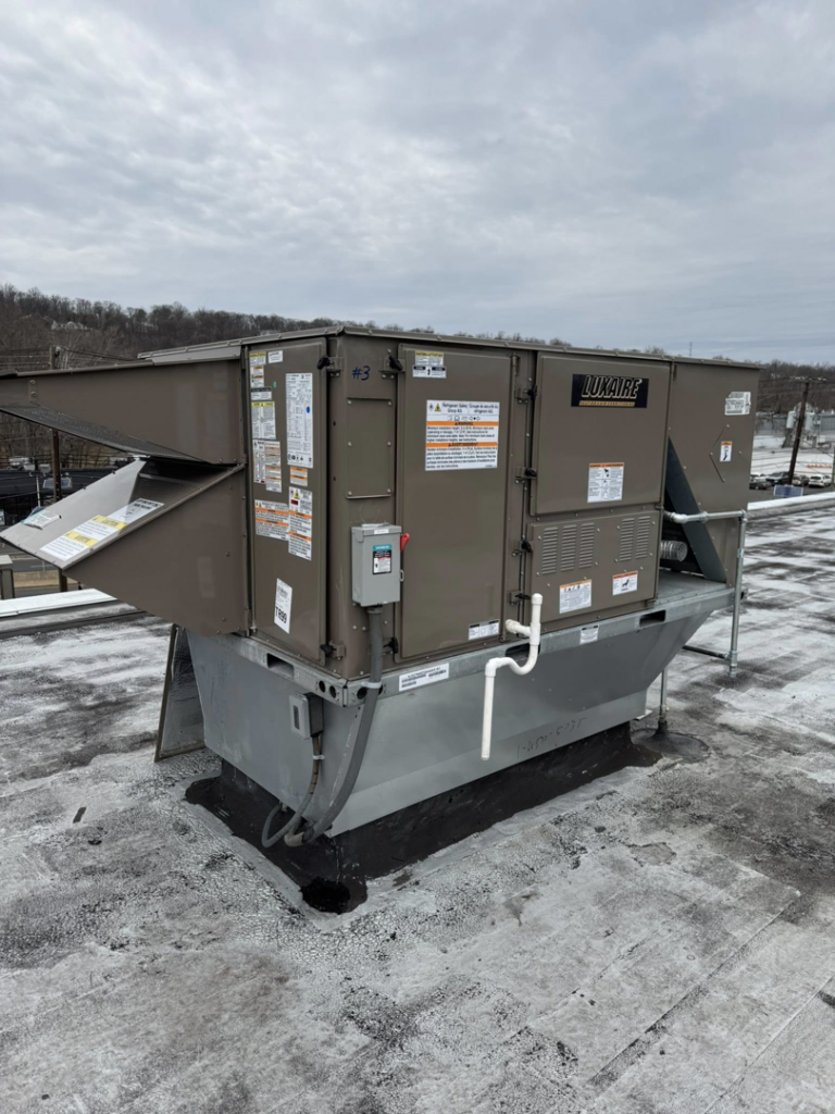 A newly installed Luxaire rooftop HVAC unit on a commercial building by Prism Heating & Air Conditioning in Toms River, NJ.
