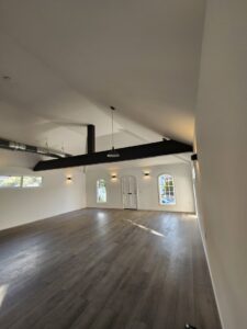 An empty room showcasing new recessed lights, wall sconces, and a pendant light installed by ALC Electric LLC in Goose Creek, SC