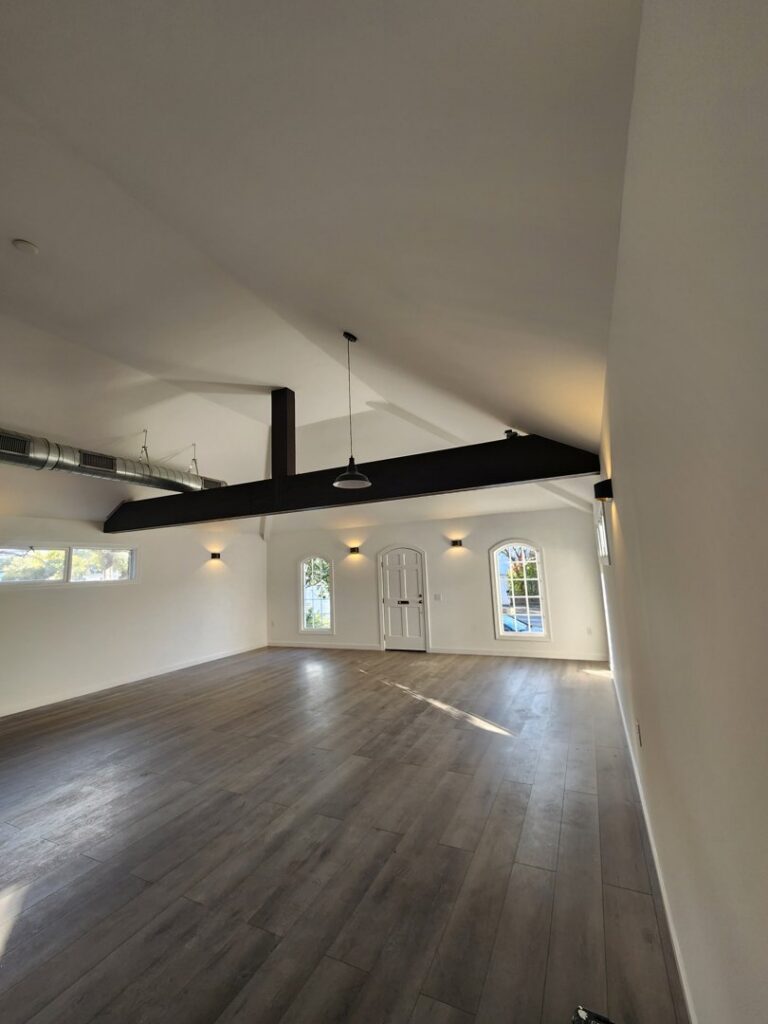 An empty room showcasing new recessed lights, wall sconces, and a pendant light installed by ALC Electric LLC in Goose Creek, SC