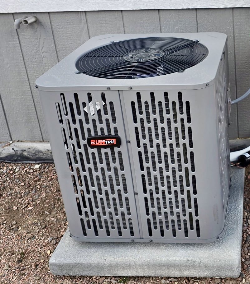 A new RunTru brand outdoor AC condenser unit installed by Lee's Heating & Cooling in Pueblo, CO.