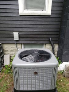 A new Ruud outdoor air conditioning unit professionally installed by Supertech Home Services for a home in Warren, MI.