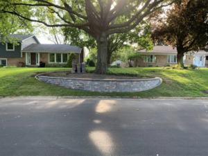 Fresh sod installation around a new retaining wall by Miguel Landscaping LLC in Janesville, WI.