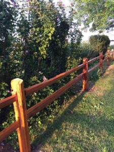 A newly installed split rail fence along a property line by Sergio's Fence in Kansas City, KS.