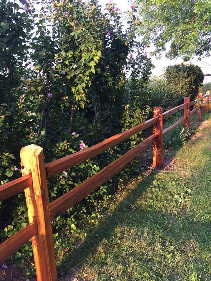 A newly installed split rail fence along a property line by Sergio's Fence in Kansas City, KS.