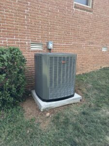 A newly installed Trane outdoor air conditioning unit next to a brick building by Breeze Heating & Cooling Nashville in Nolensville, TN.