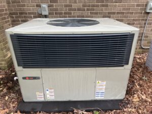 A newly installed Trane HVAC condenser unit outside a home by Integrity Services Heating and Cooling in Madison, AL.