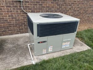 A new Trane outdoor HVAC unit recently installed on a concrete pad by A/C Company Since 1988 in Murfreesboro, TN.