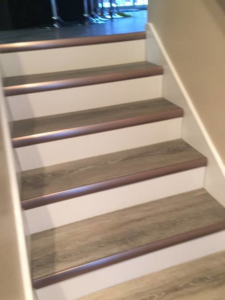 Newly installed vinyl plank flooring with matching nosing on a staircase by Alaska Flor-Wall, Inc. in Anchorage, AK.