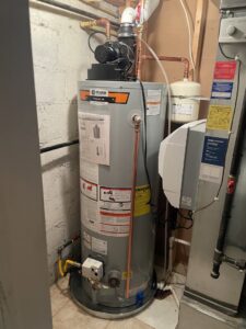 A newly installed water heater next to an HVAC system by Comfort-Tech llc, an HVAC contractor in Alexandria, VA.