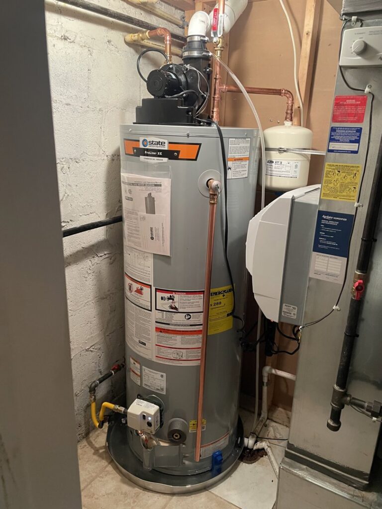 A newly installed water heater next to an HVAC system by Comfort-Tech llc, an HVAC contractor in Alexandria, VA.
