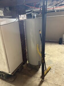 A newly installed water heater in a utility area, serviced by TAS Mechanical Services in Kearney, MO.