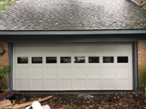A newly installed white garage door with small windows, showcasing a completed project by Door-Tech LLC in Lexington, KY.