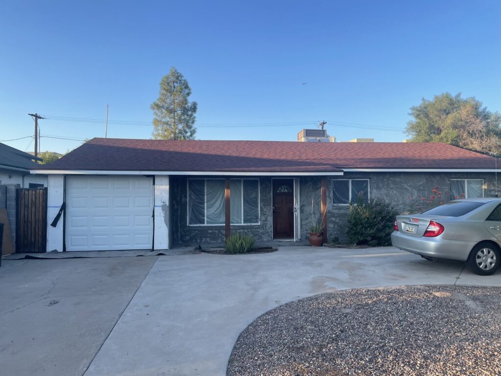 A newly installed white garage door on a residential property by Absolute Garage Doors LLC AZ in Mesa, AZ