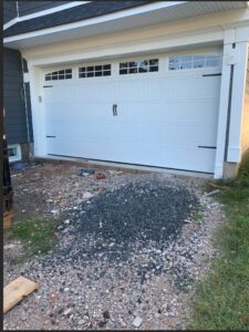 A newly installed white garage door on a residential home by Team Garage Doors in Mesa, AZ.
