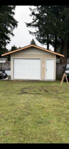 A newly installed white garage door on a detached shed by Steadfast Garage Door Services LLC in Federal Way, WA.