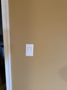 A newly installed white light switch on a beige wall by Valence Solutions LLC in Stevens, PA