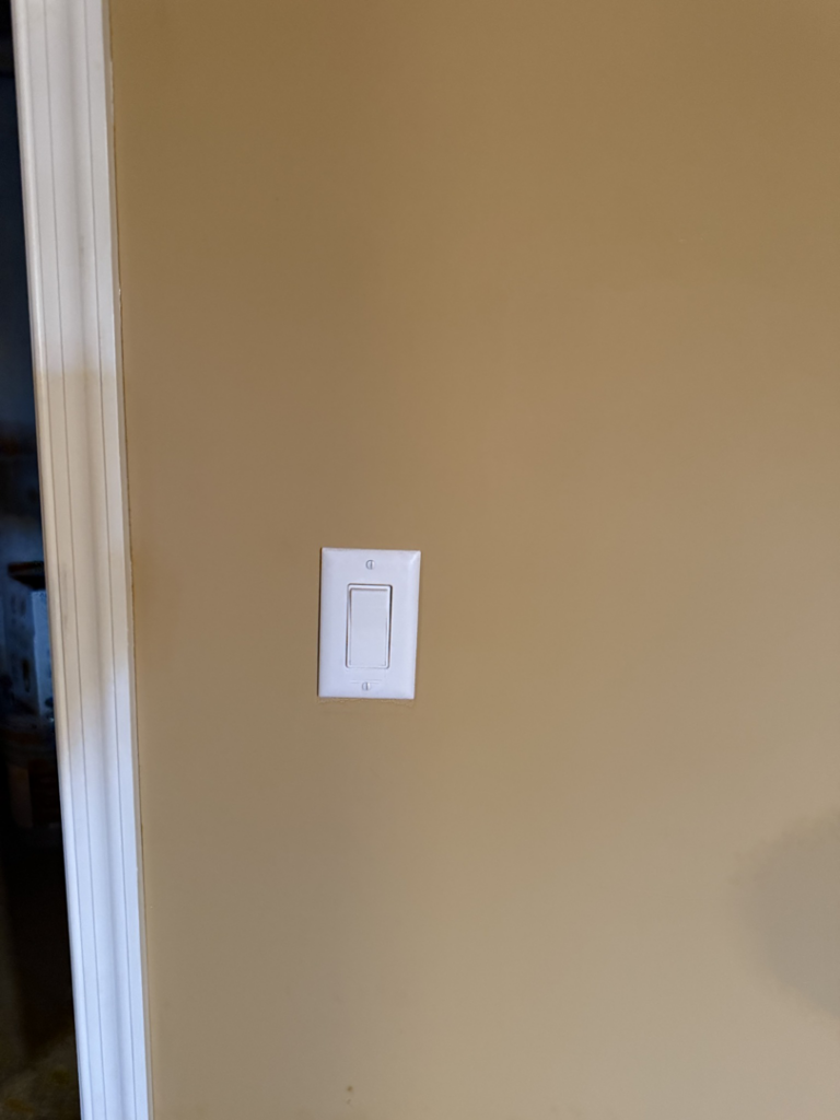 A newly installed white light switch on a beige wall by Valence Solutions LLC in Stevens, PA